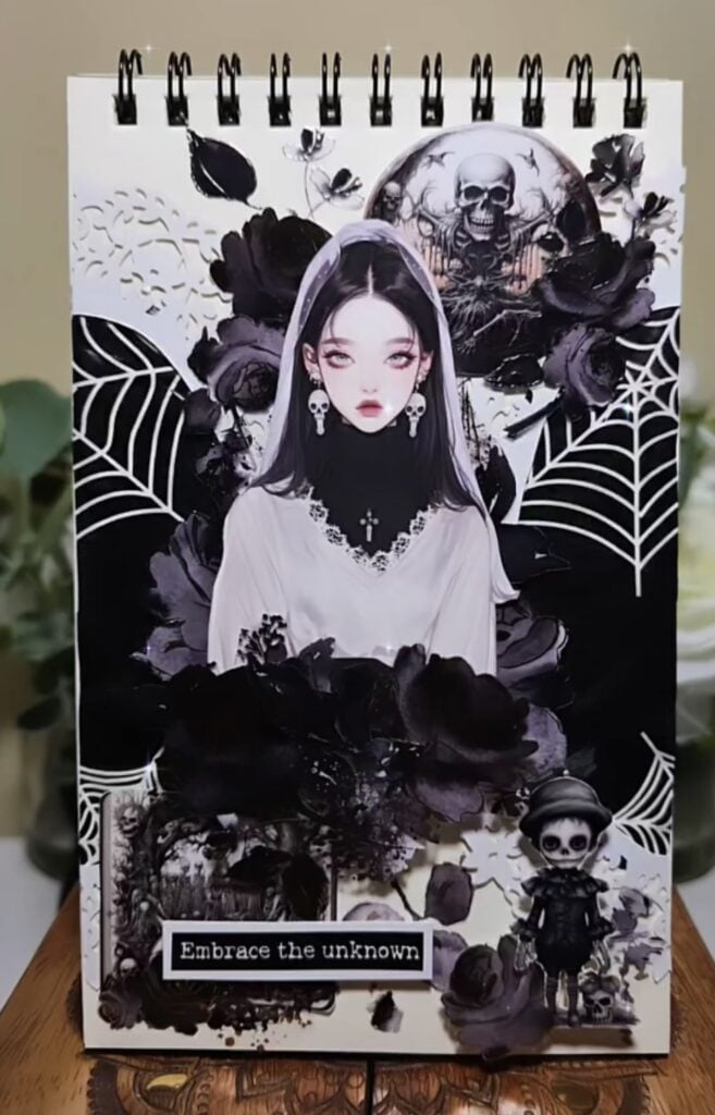 Gothic Halloween scrapbook layout with moon, roses, and vintage girl portrait on moody background.