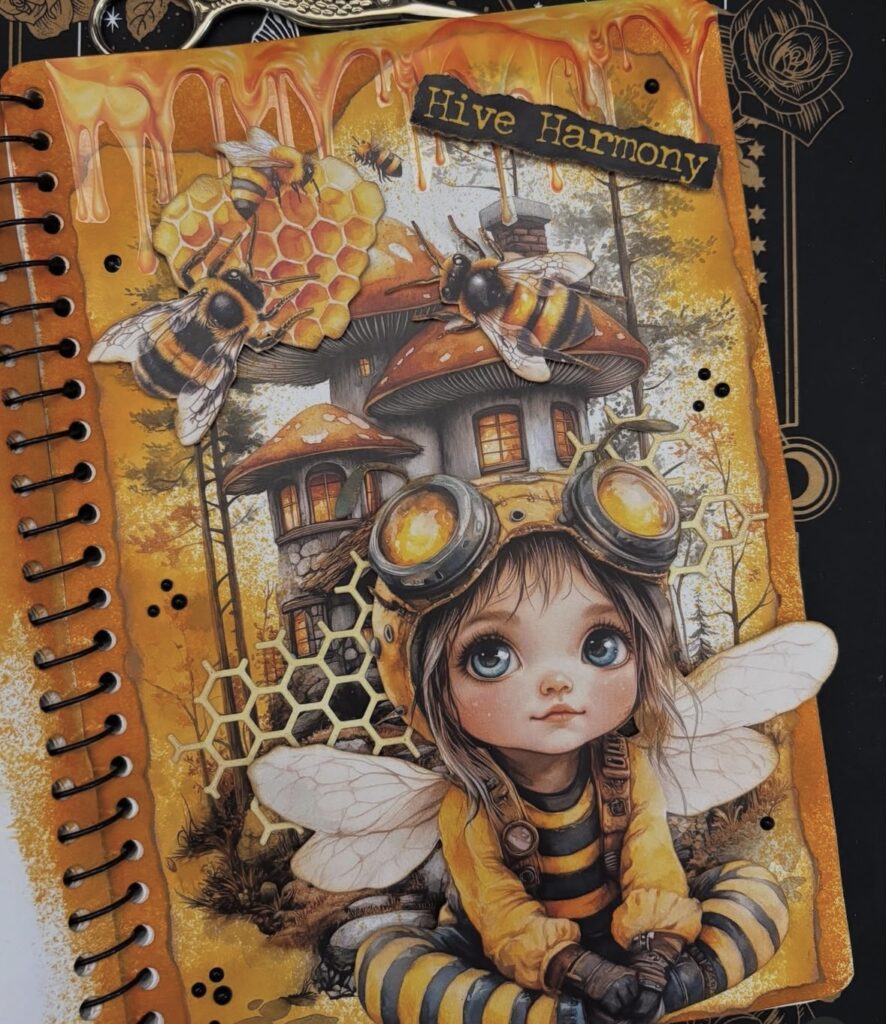 Orange junk journal page with cut-out images, handwritten text, and layered backgrounds. Credit: lannys_artjournals on Instagram.
