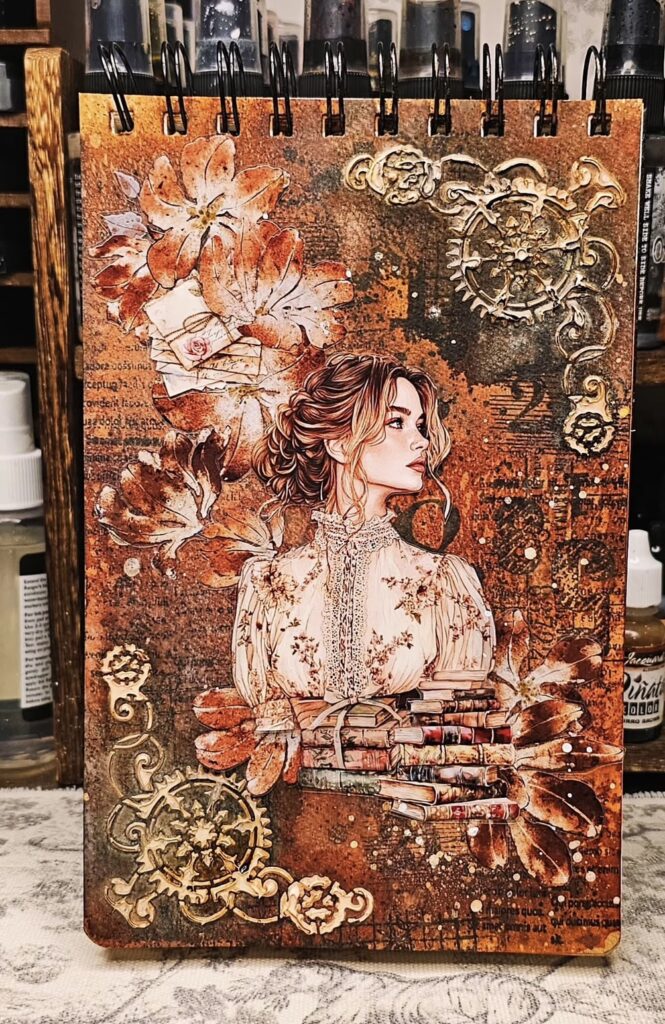 Orange-themed scrapbook spread with patterned paper, vintage accents, and creative borders. Credit: cherry_moon_nim on Instagram.