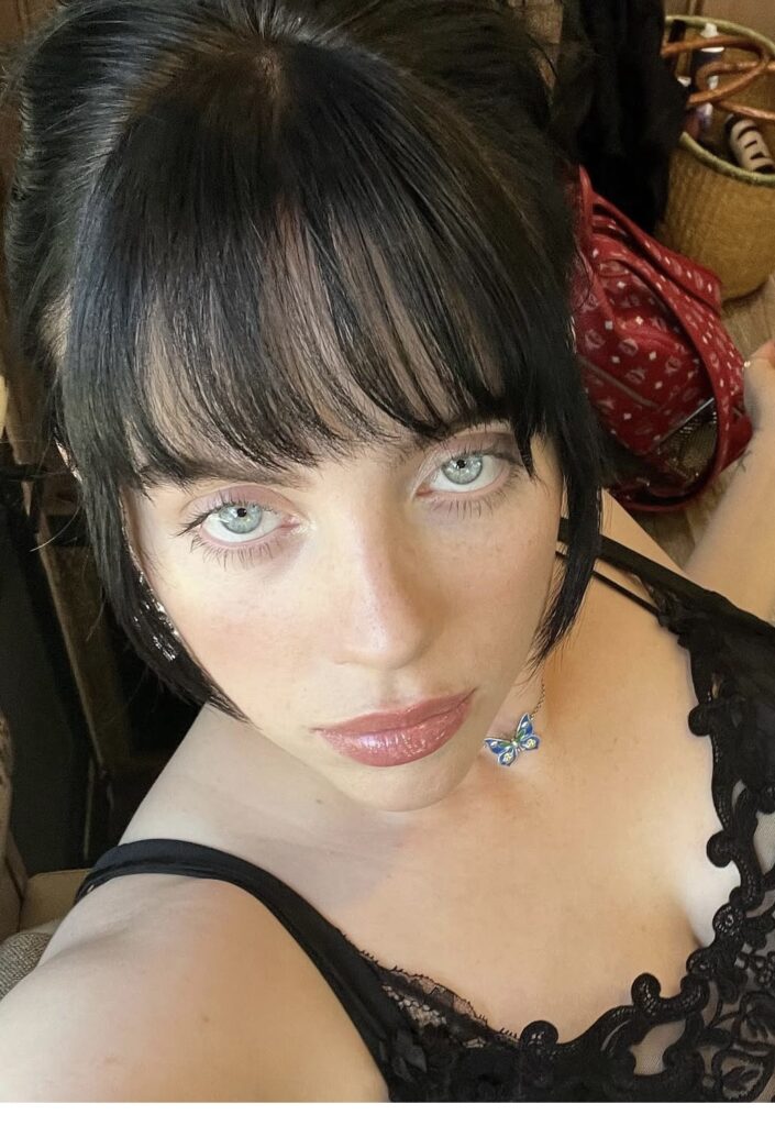 Close-up of Billie Eilish’s iconic blue eyes and makeup, inspiration for recreating her signature look for Halloween. Photo credit: @billieeilish on Instagram via Slowestuff.com
