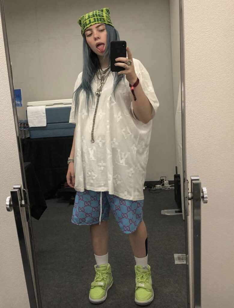 Billie Eilish with a green headband and matching outfit, another fun and easy Halloween costume idea. Photo credit: @billieeilish on Instagram via Slowestuff.com