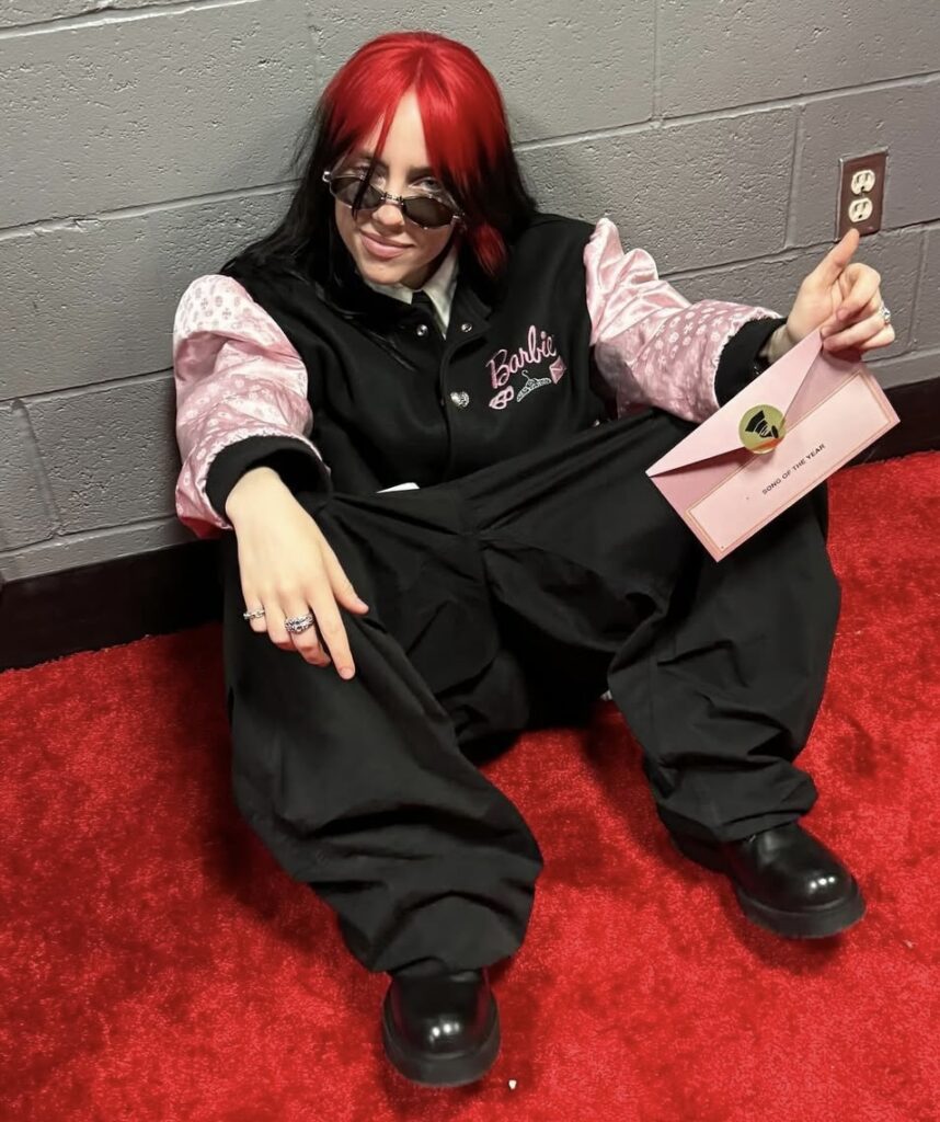 Billie Eilish in her red hair Barbie fit, as seen during the Barbie movie promo and award shows. Halloween costume idea via Slowestuff.com
