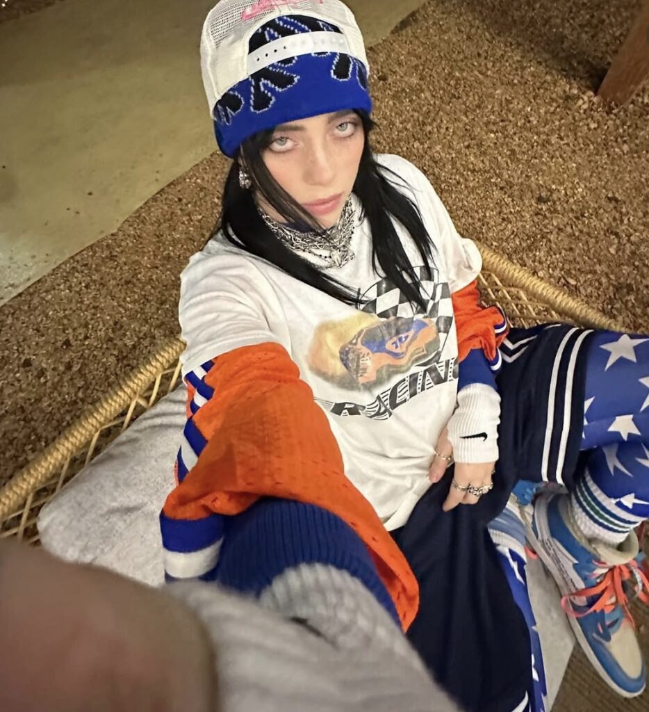 Billie Eilish with her classic black hair and layered streetwear, a popular Halloween costume idea. Photo credit: @billieeilish on Instagram via Slowestuff.com