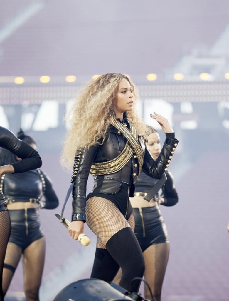Beyoncé Super Bowl halftime show costume—black bodysuit, military jacket, and thigh-high boots, ultimate Beyoncé Halloween costume | Slowestuff.com