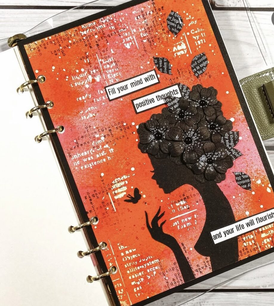 Orange aesthetic scrapbook journal spread with hand-drawn elements and layered paper. Credit: liu_journal on Instagram.
