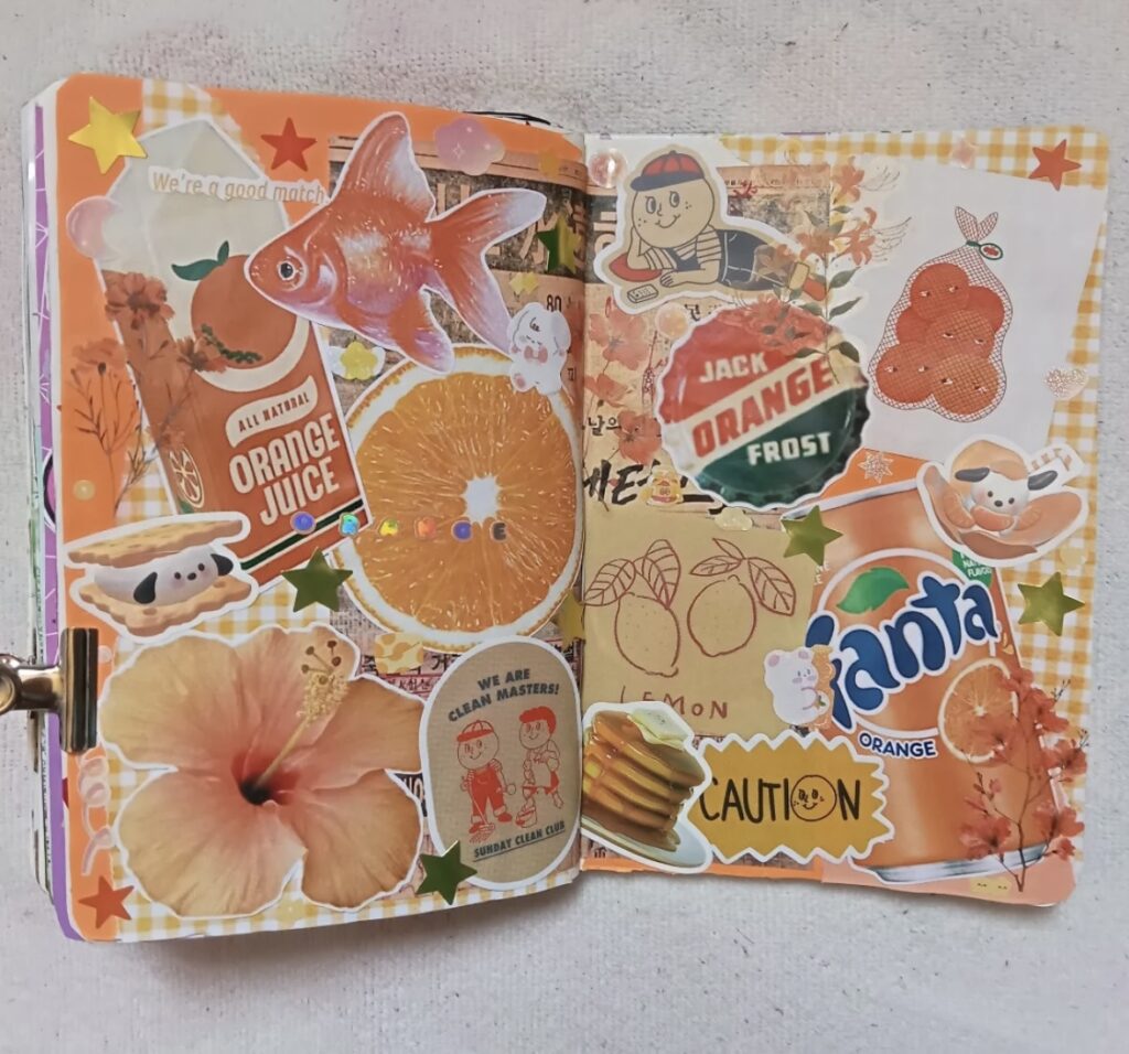 Scrapbook page using orange with layered photos, ephemera, and playful hand-lettered accents. Credit: america.doodles on Instagram.