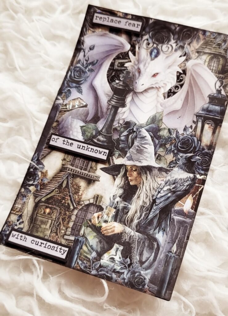 Mystical junk journal page showing a wise old witch with long gray hair, surrounded by celestial embellishments, dark moody hues, and hints of ancient spells. Credit: @cjartdecor