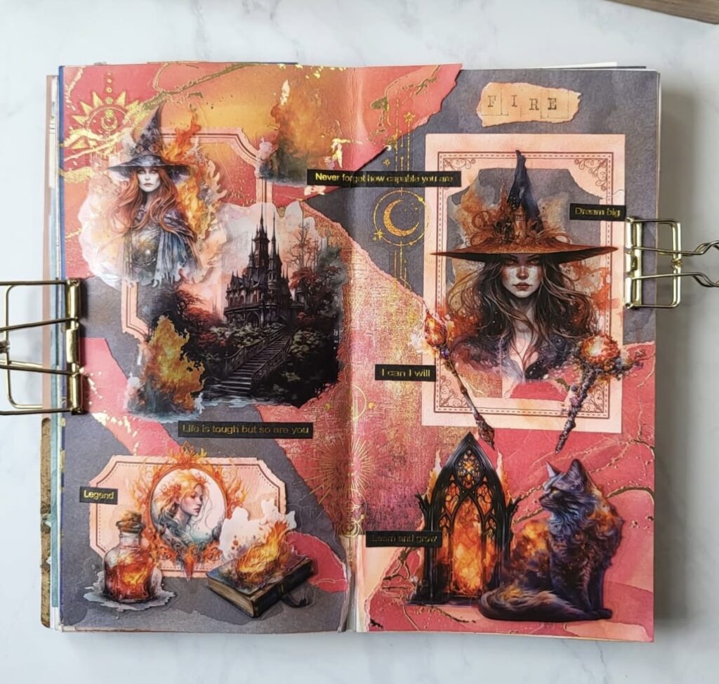 Fiery journal spread with red and gold collage, magical flames, gothic castle, spell books, and a mystical cat. Credit: @lazylattejournal