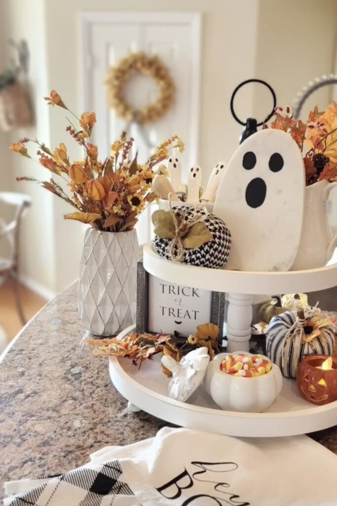 Wooden ghost with a natural jute coaster, pale taupe pumpkins, and dried wheat accents styled on a wood tray—love this natural, neutral ghosty look. Credit: simple.joy.at.home.