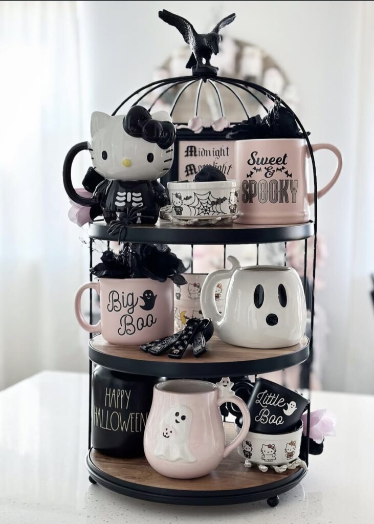 Girly pastel ghost tiered tray with pink pumpkins, sparkly stars, and smiling ghost figures for a fun, sweet Halloween vibe. Credit: wild4raedunn.