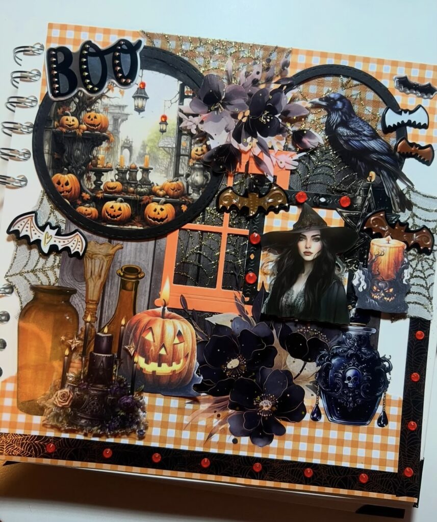 Classic Halloween scrapbook layout with a bold orange and black color scheme, layered “BOO” title, jack-o’-lanterns, bats, sparkly florals, and a raven for true October vibes. Credit: @mamas.scrapbooking