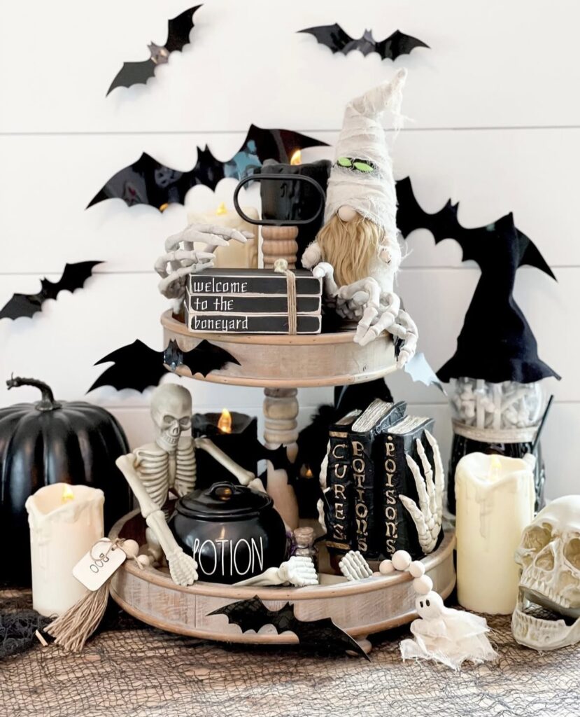 Spooky tray for Halloween featuring skeleton figurines, black cats, skull mugs, spiderweb accents, and festive Halloween details. Skeleton tray inspiration at www.slowestuff.com.