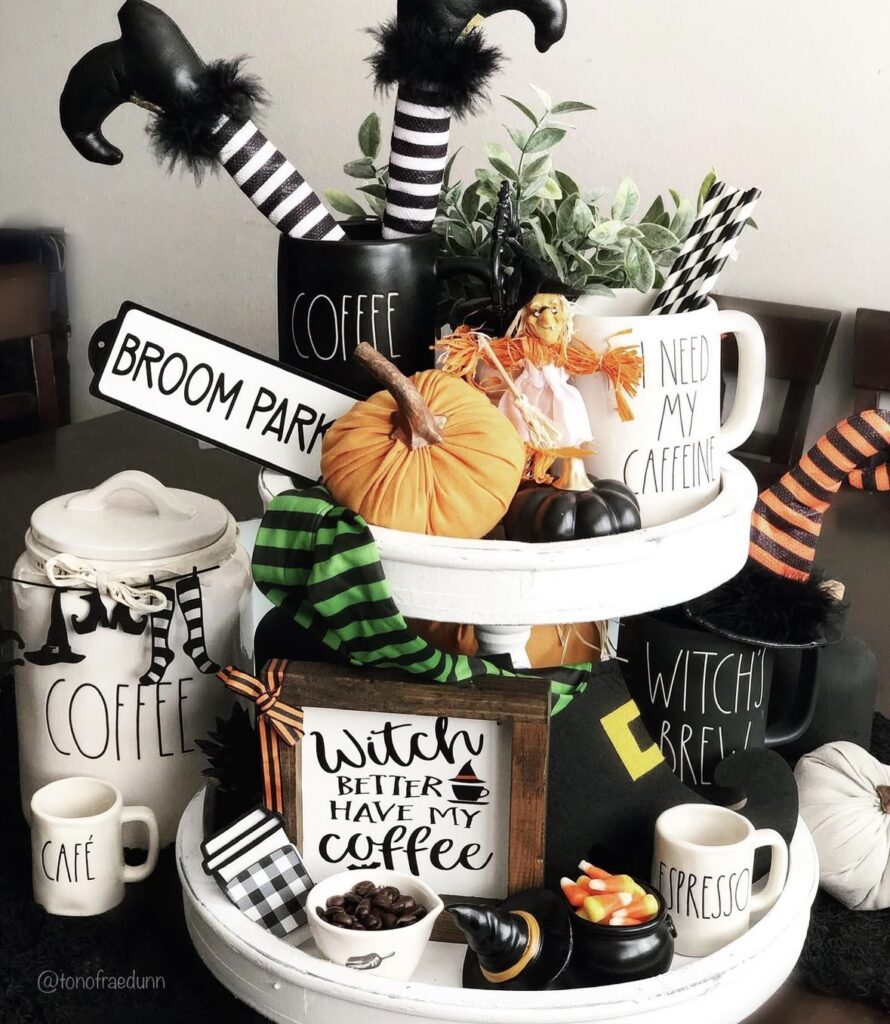 Witch themed Halloween tiered tray styled with Rae Dunn mugs, witch legs in coffee mug, and lime green decor accents. Credit: tonofraedunn, www.slowestuff.com