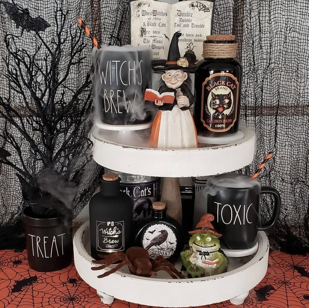 Rustic Halloween witch tiered tray with a witch figurine, poison bottles, tiny skeletons, and faux smoke details. Credit: bluesparrowandpeonies, www.slowestuff.com