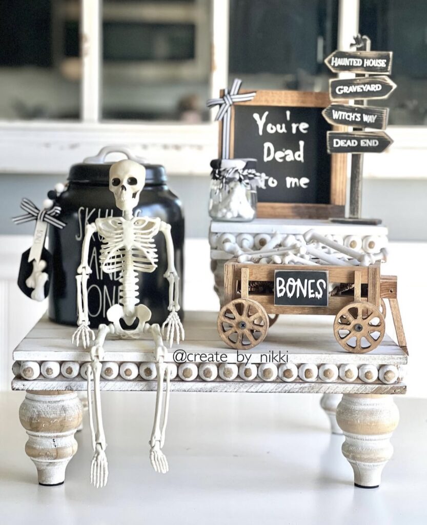 Hayride inspired Halloween tray with skeleton figure, graveyard sign, wagon, and sign that says you're dead to me. Discover more skeleton decor ideas at www.slowestuff.com.