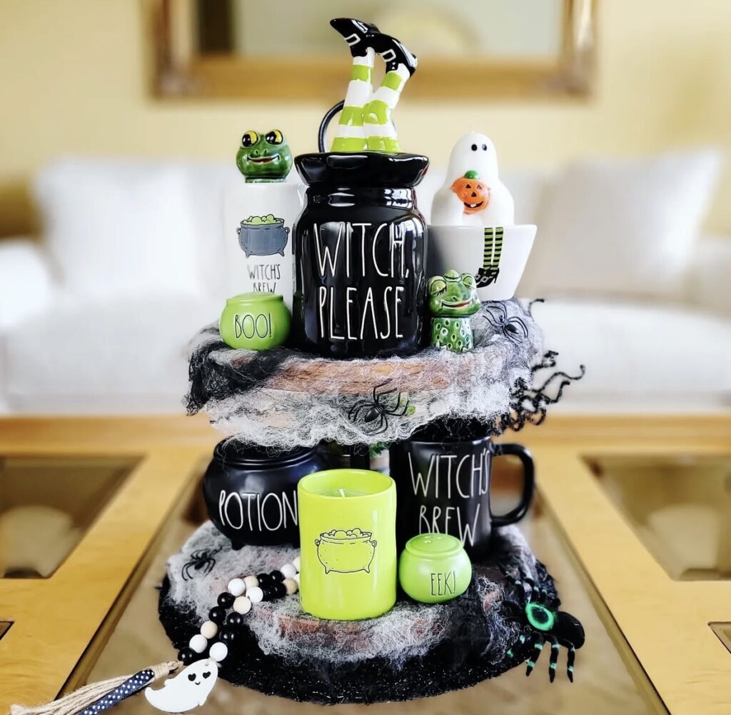 Cute witch themed Halloween tiered tray with witch legs in green and white striped leggings, spider cobwebs, and lime green accents. Credit: gemma.and.gianni, www.slowestuff.com