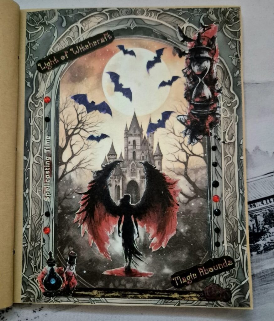 Spooky castle-themed scrapbook page with a moonlit background, witch with red and black wings, and dramatic, moody castle details. Credit: @sweetvalkyrie_journaling