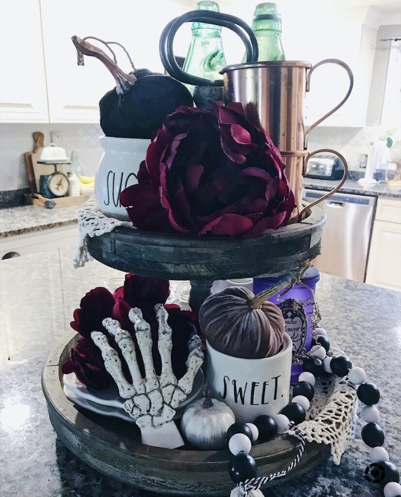 Gothic Halloween skeleton tray with skeleton hand, rich blood red large roses, pumpkins for a spooky centerpiece. See more at www.slowestuff.com.