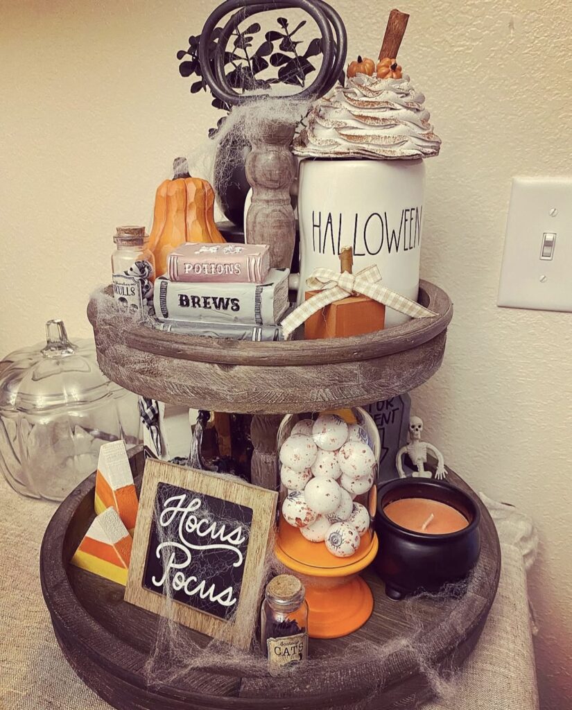 Witchcore neutral tiered tray with brews and potions books, candy corn, and soft fall colors. Credit: midwestlucy, www.slowestuff.com