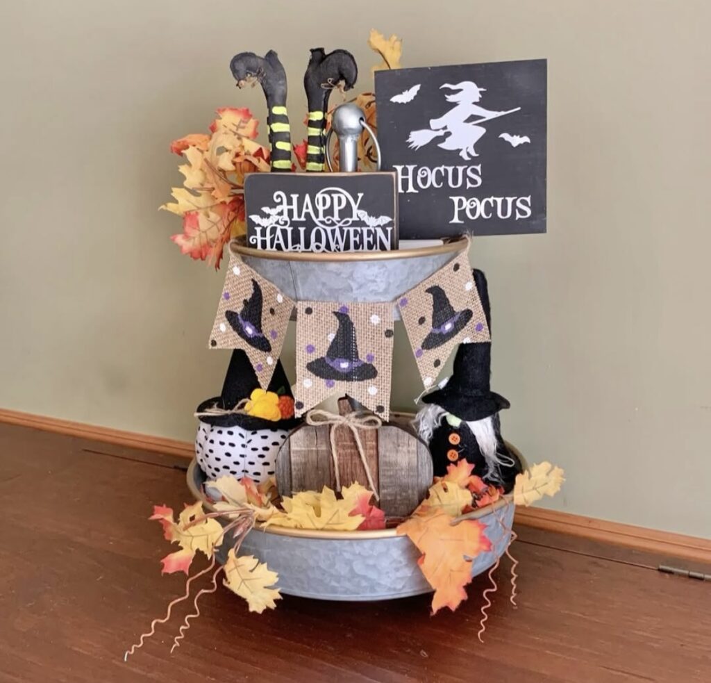 Tin tray decorated for Halloween with witch hat, witch legs, “Hocus Pocus” sign, and fall pumpkins. Credit: sayitinburlap, www.slowestuff.com