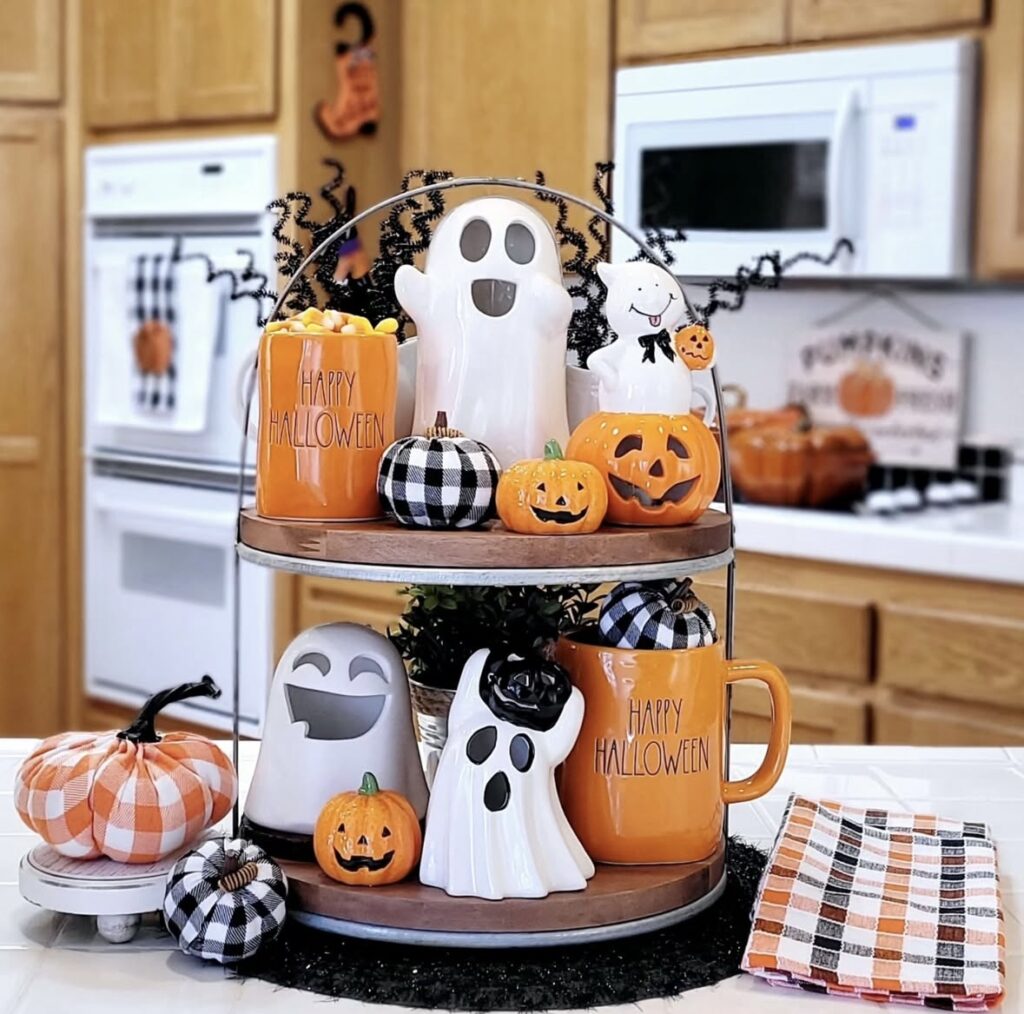Bright and colorful plaid tiered tray with ghost figurines, orange accents, and pops of teal for a playful Halloween statement. Credit: gemma.and.gianni.