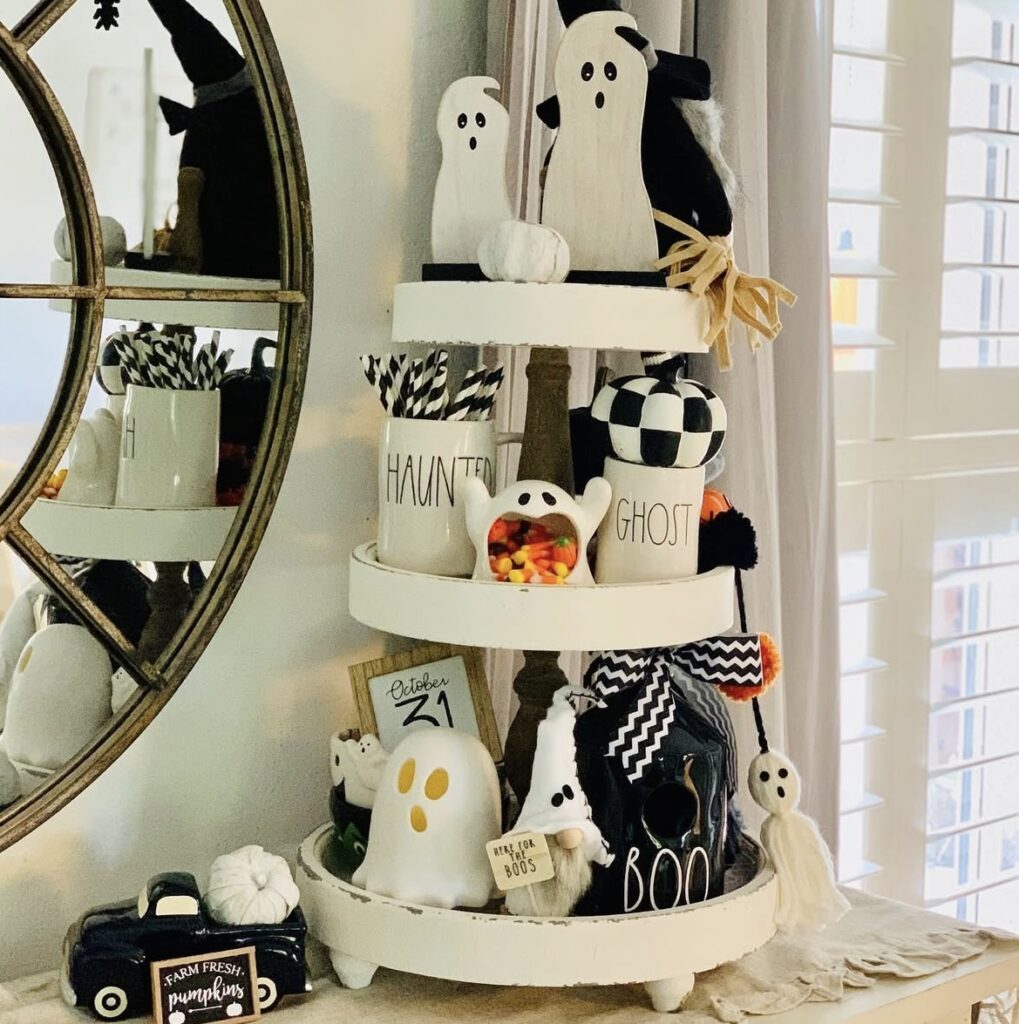 hite tray with orange accents and cute ghost decor, styled for a clean, bright Halloween look. Credit: fiveonthelane.