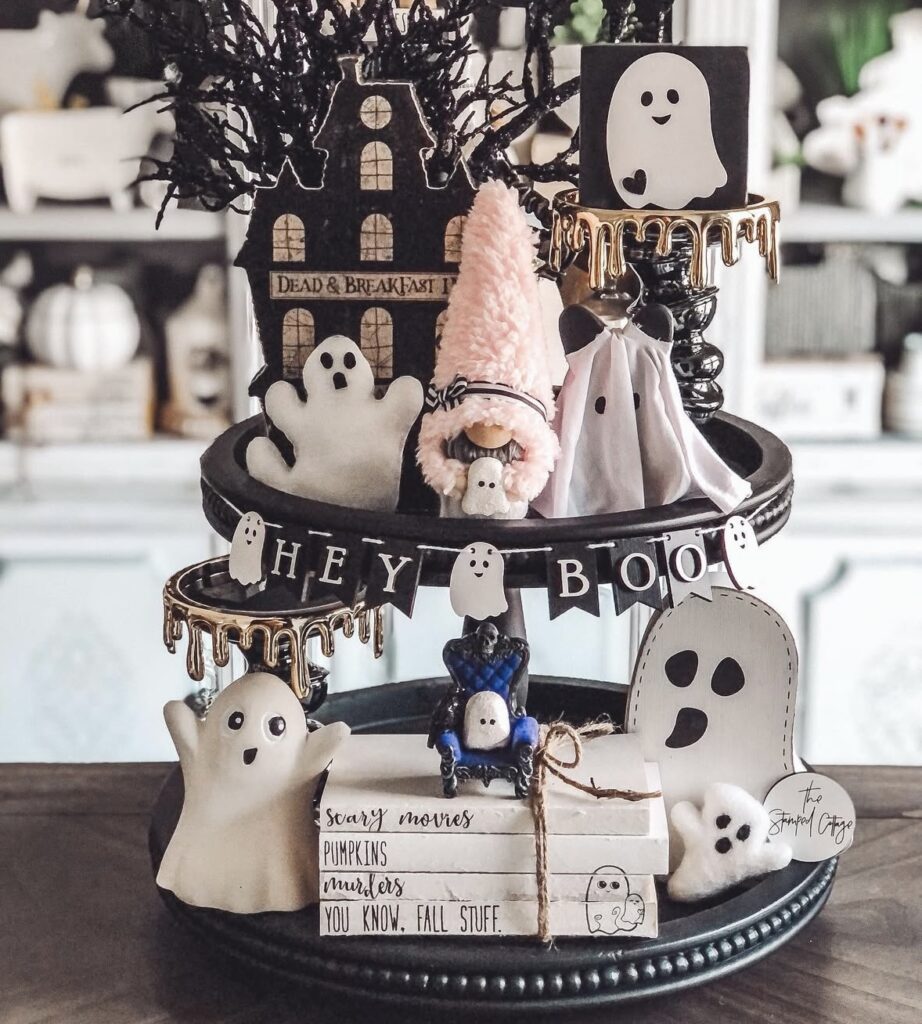 Gorgeous ghost tiered tray black and white with pink accents, ghost cut outs and figurines and a hey boo banner Credit: thestampedcottage