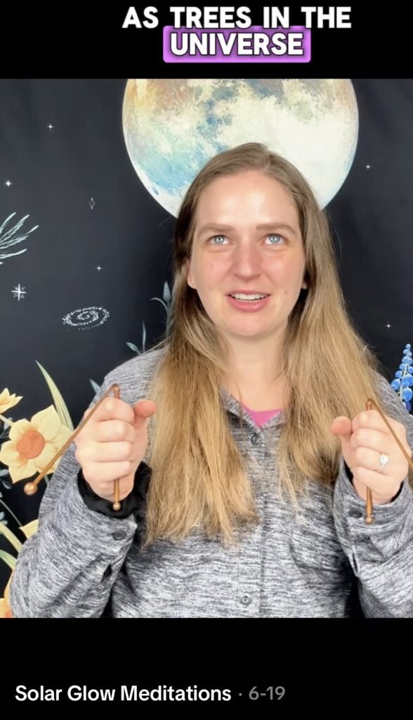 Image of Solar Glow Meditations creator holding dowsing rods, from the viral TikTok trend. Fun idea for a unique Halloween costume in 2025.