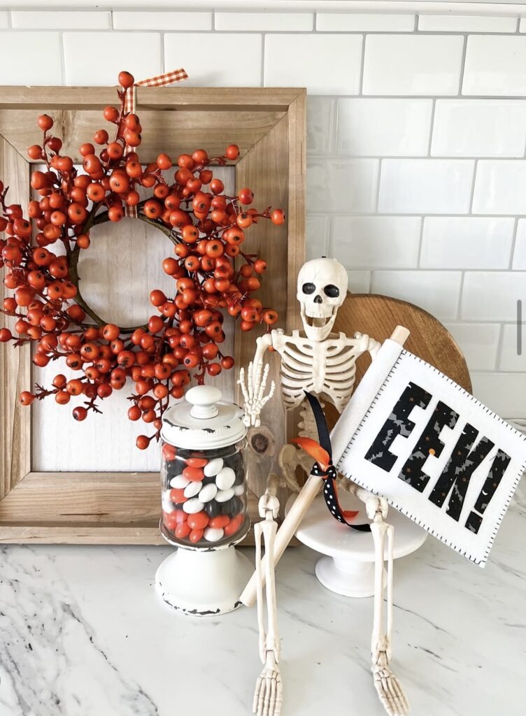 Simple Skeleton-themed tray decor idea, with fall wreath, rustic frame and halloween candy. Halloween decor. Get skeleton tray ideas at www.slowestuff.com.