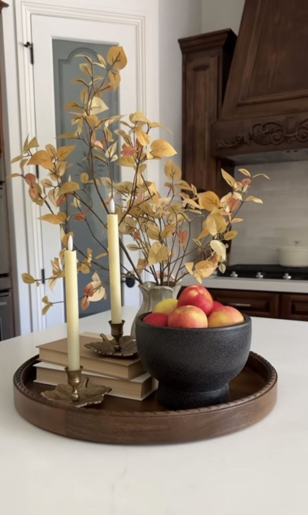 Round fall tray with apples, floral arrangement, and candles