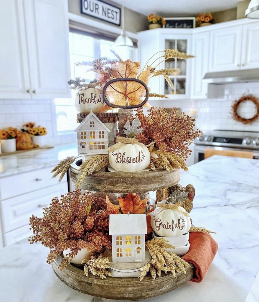 Full texture tiered tray with a little houses, fall foliage and seasonal pumpkins