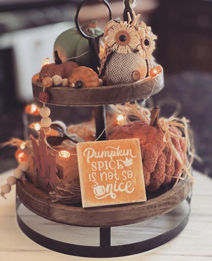 Tiered tray for fall with twinkle lights, fabric decorations and sign about pumpkin spice