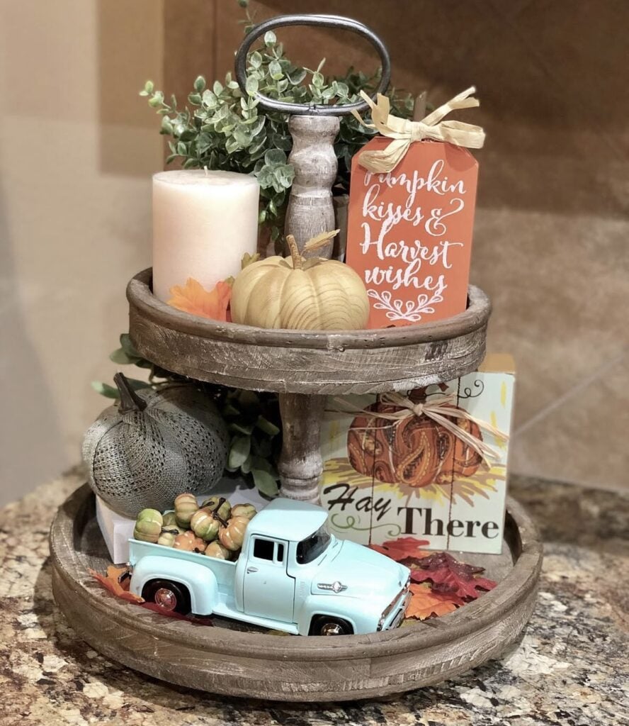 Rustic tiered tray for fall with fall colors accented with a pale turquoise truck
