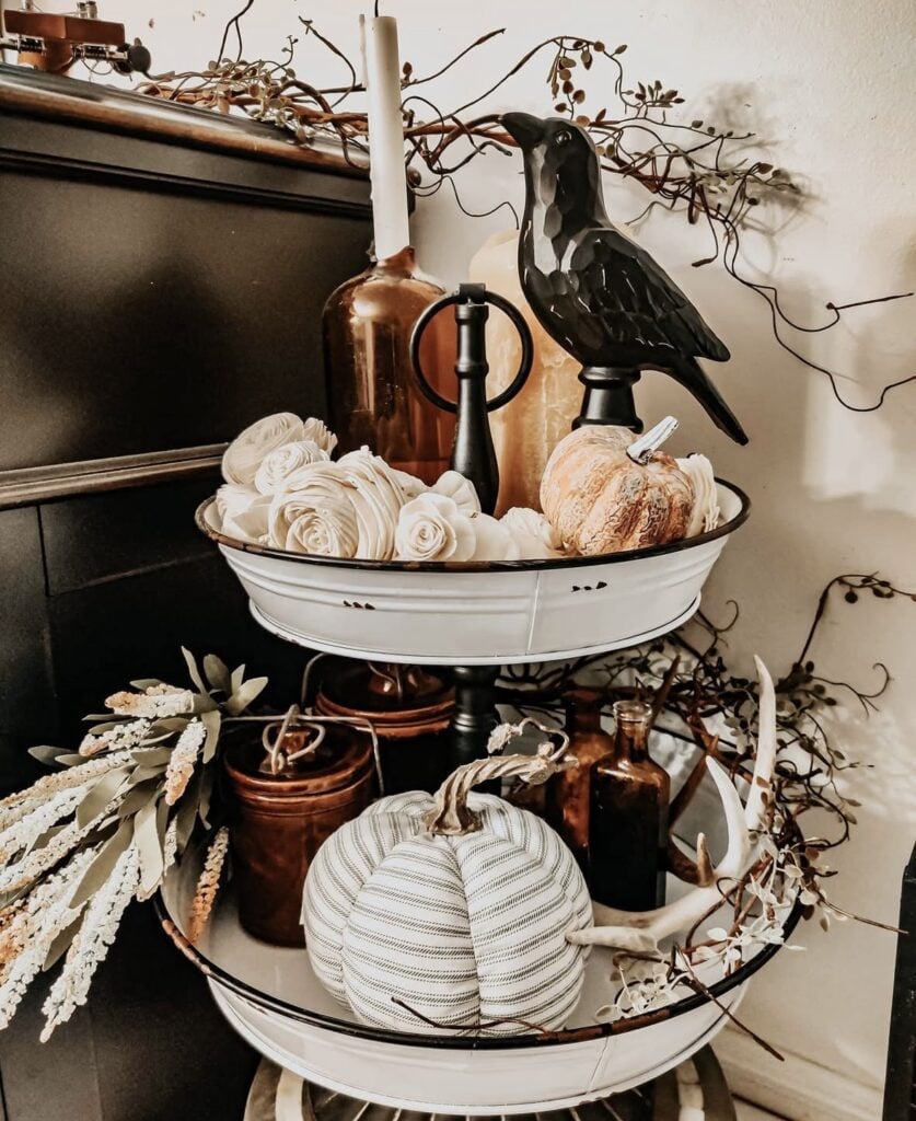 Tin tiered tray for fall with witchy vibe with candle, crow, pumpkins and wheat