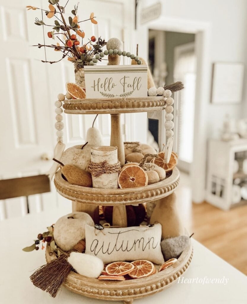 Fall tiered tray with dried orange slices, foliage and autumn signs