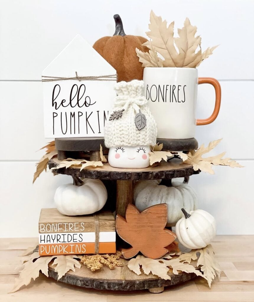 Two tierd tray for fall with wooden base and campfire decorations in fall colors of pumpkin and white