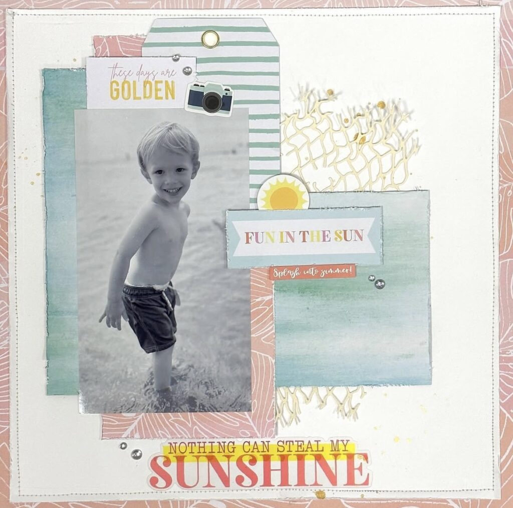 Summer beach scrapbook page featuring a black-and-white photo of a little boy standing in shallow water, layered tags and teal papers, a “FUN IN THE SUN” label, and the title “Nothing Can Steal My Sunshine.”