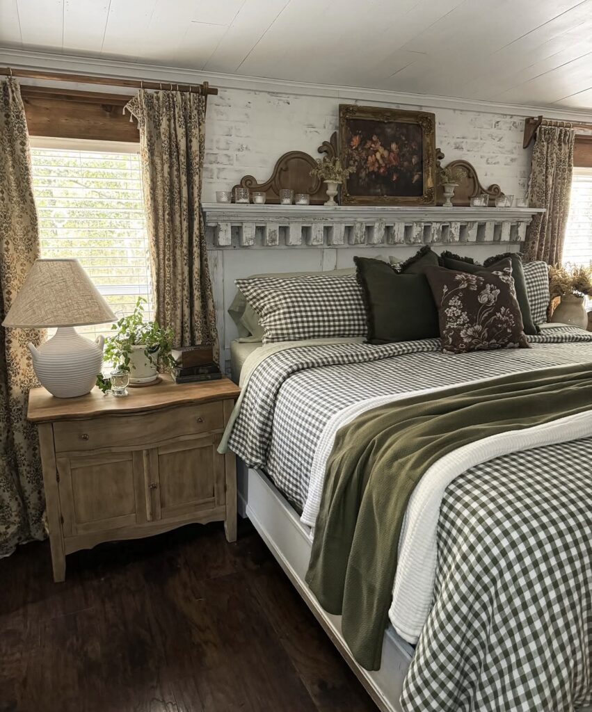 vintage-inspired fall bedroom with green and brown gingham bedding, floral pillows, and distressed wood furniture