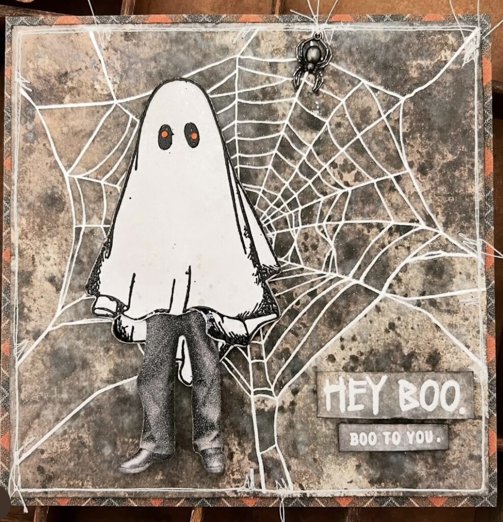“Hey Boo” handmade card with smiling ghost on a black web background, enamel dots, and orange florals.