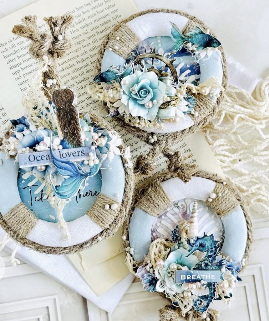 Nautical life preserver wreath tags with blue florals, pearls, and jute twine on a book page background, labeled “Ocean lovers.”