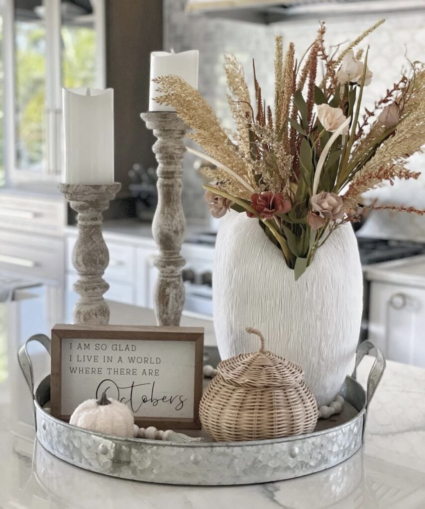 Galvanized tray with white vase, wicker pumpkin, and candles