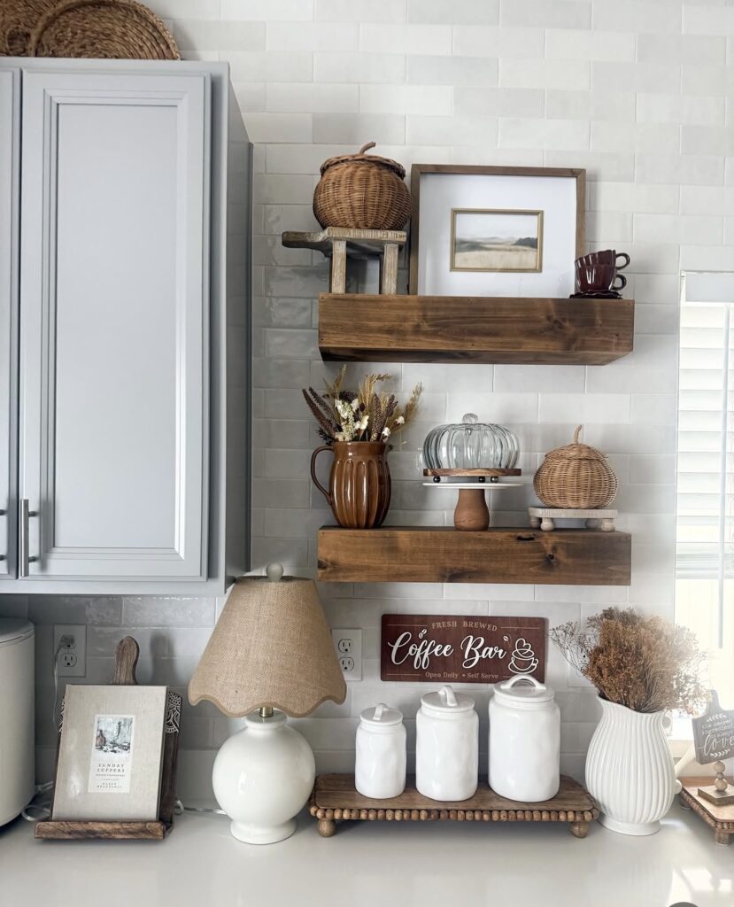 Rustic kitchen coffee bar corner with floating wood shelves, wicker baskets, and neutral fall decorations