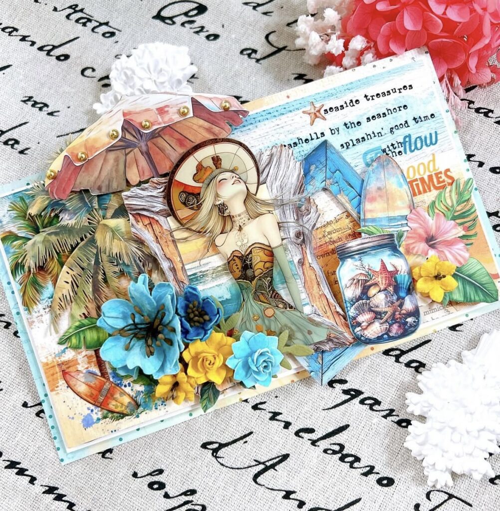 Handmade seaside junk journal collage with a beach girl illustration, palm trees, surfboard, jar of seashells, and bright blue and yellow flowers in a layered tropical layout.