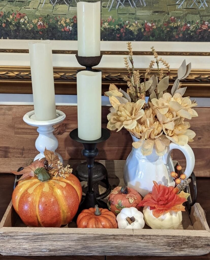 Square tray with pumpkins, yellow flowers, and fall candles