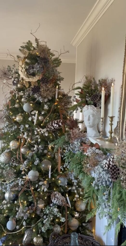 Elegant glam Christmas tree with dried white hydrangea clusters, antique-gold ornaments, soft white lights, and matching gold candles on the mantel.