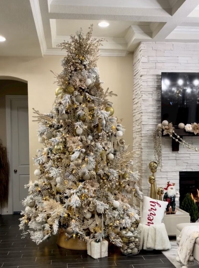 Neutral gold glam Christmas tree with frosted branches, mesh ribbon, and elegant holiday ornaments.