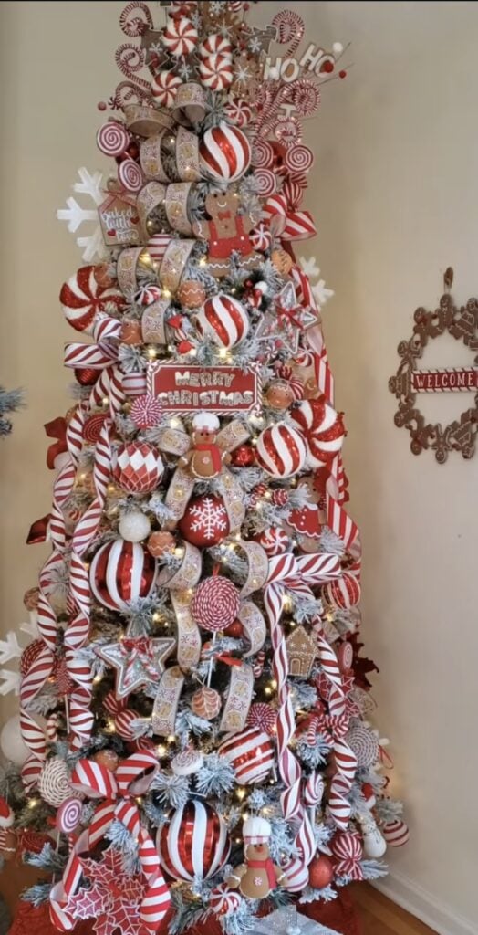 Peppermint candy-cane glam Christmas tree with gingerbread and red-and-white décor.