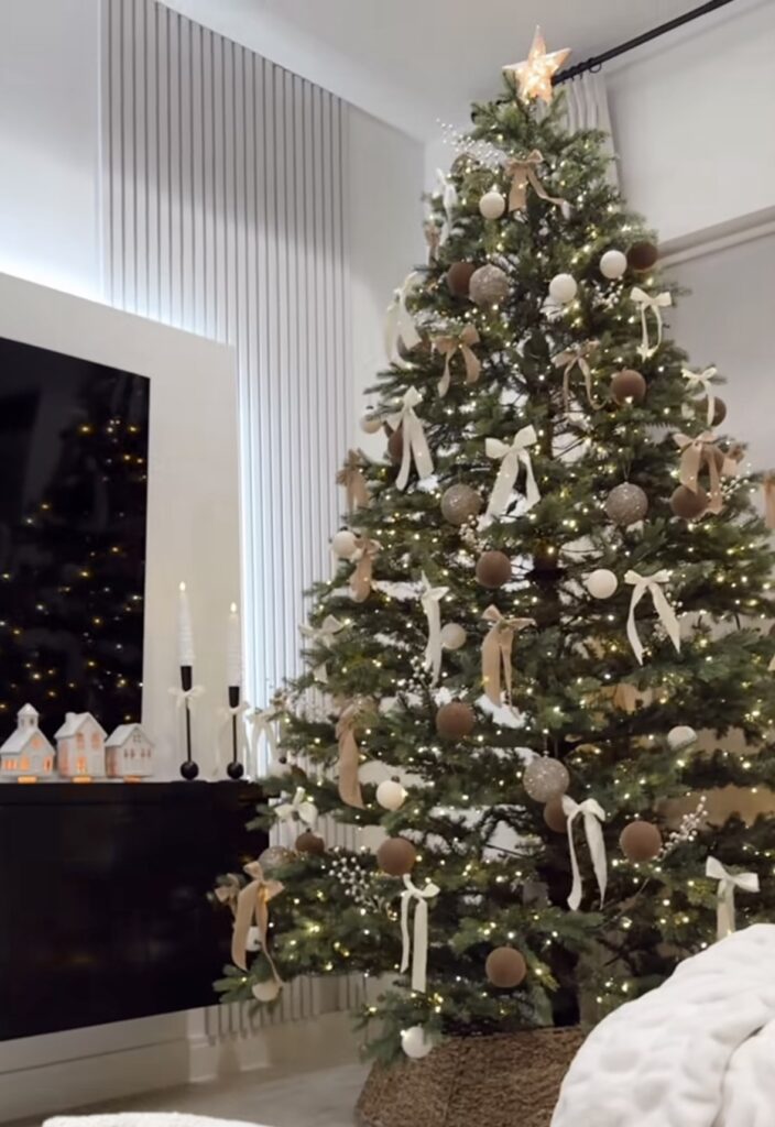 modern neutral cocoa and cream tree with matte velvet baubles, ivory and tan bows, white berry stems, star topper, wicker collar