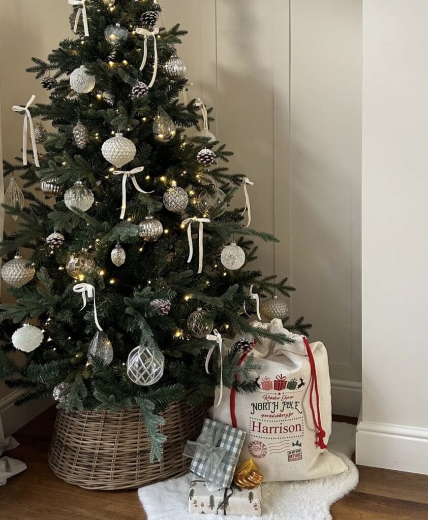neutral basket-base Christmas tree with white ribbons and glass ornaments for a scandi classic look