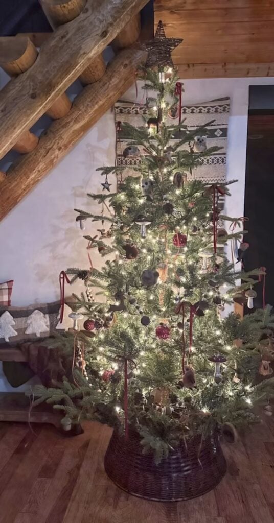 rustic-log-cabin-tree—sparse-natural-fir—burgundy-velvet-bows—mushroom-ornaments—wicker-collar